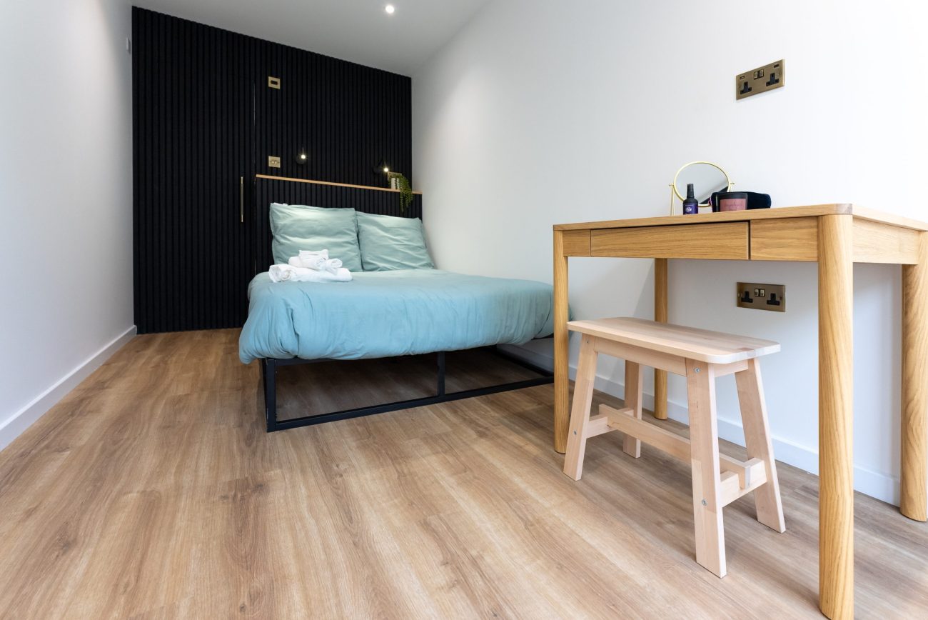 Interior of the Coorie Plus with Bed and Desk